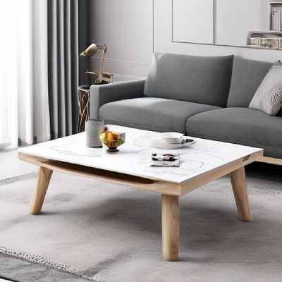 This is White coffee table with flower and coffee cup placed over it